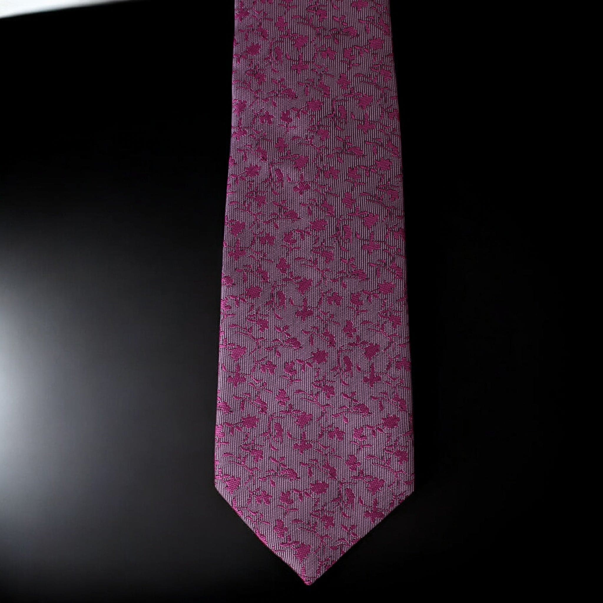 Pink floral patterned tie on a black background