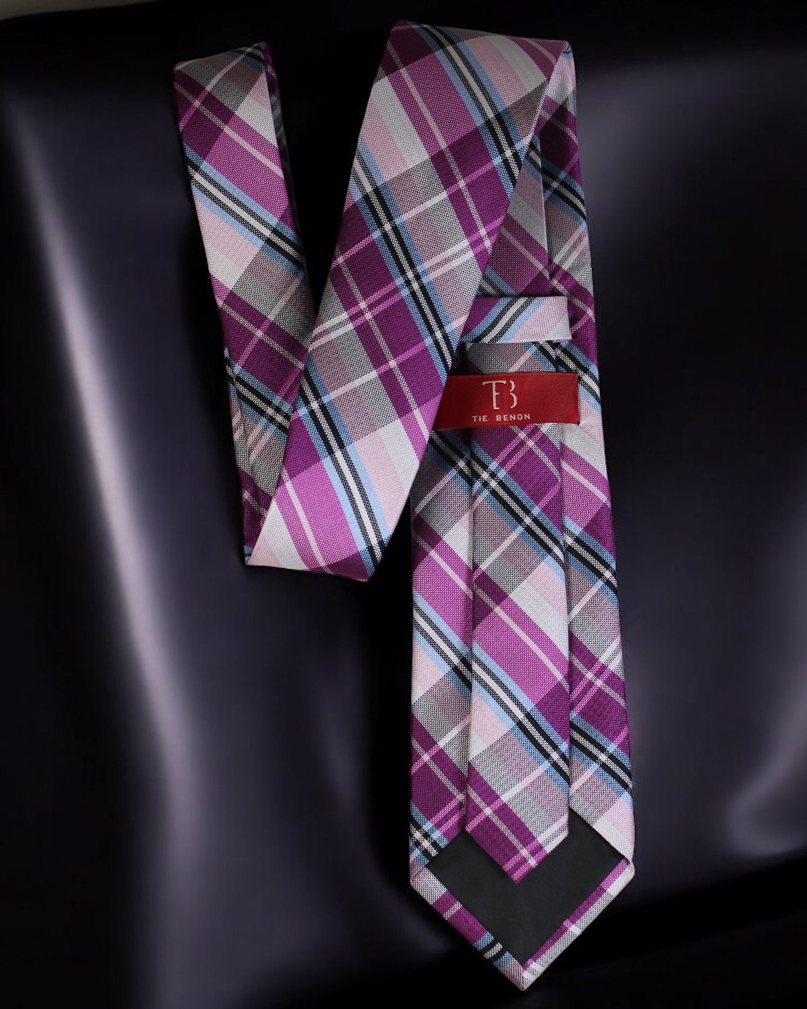 Plaid tie with a visible brand tag on a dark background Tie Benon
