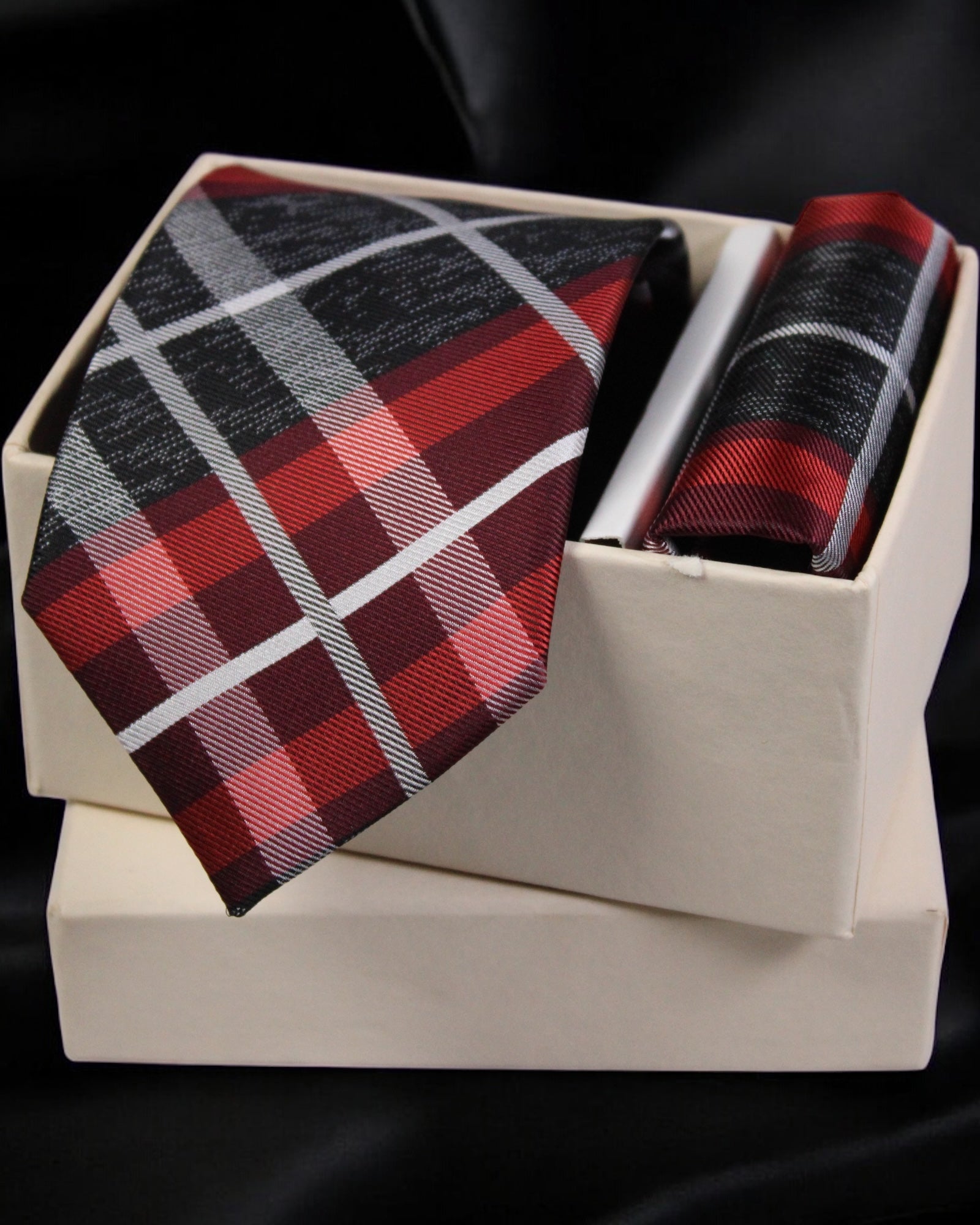 Plaid tie and pocket square set in a white box on a black background Tie Benon