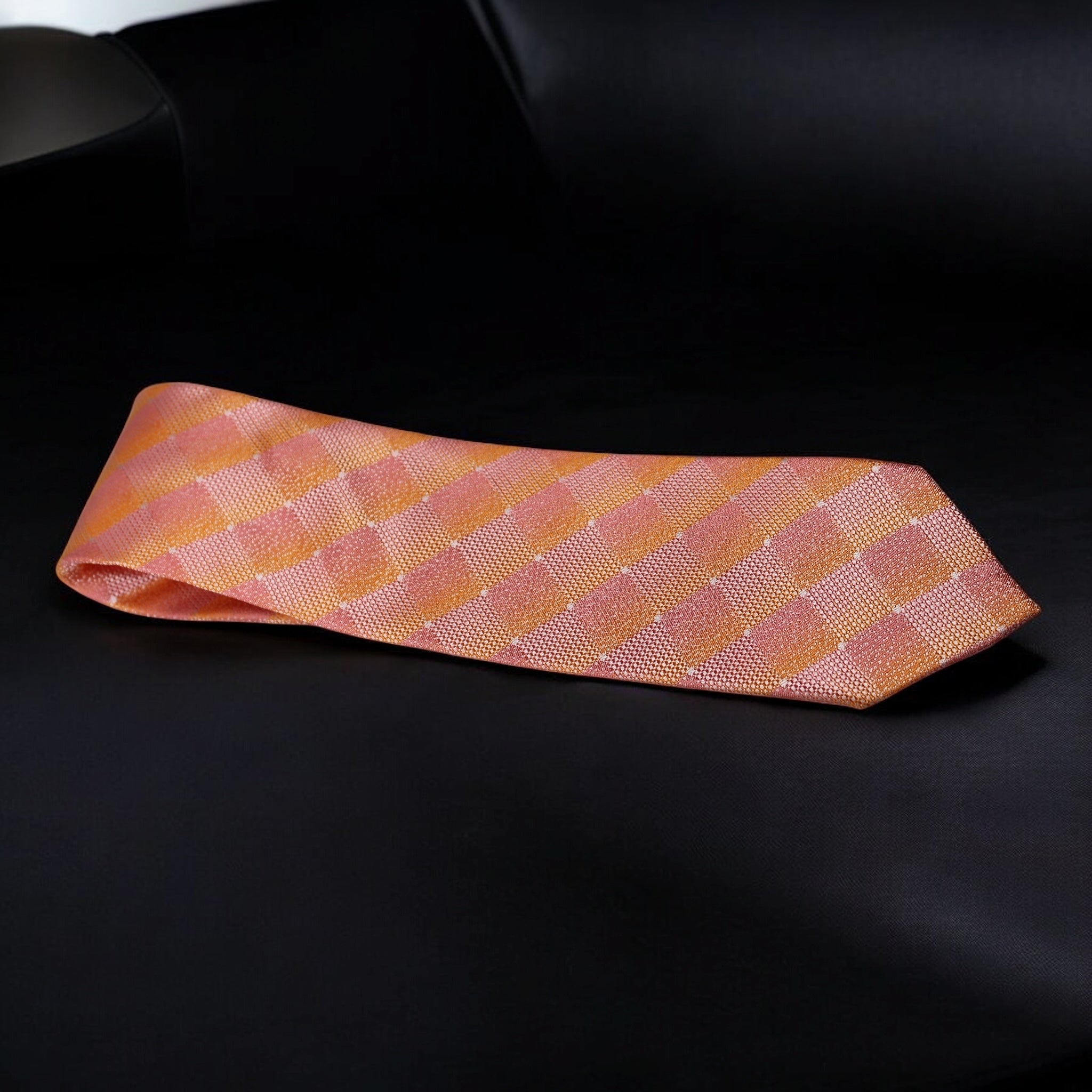 Pink checkered tie on a black background