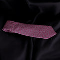 Pink floral tie on a black satin background