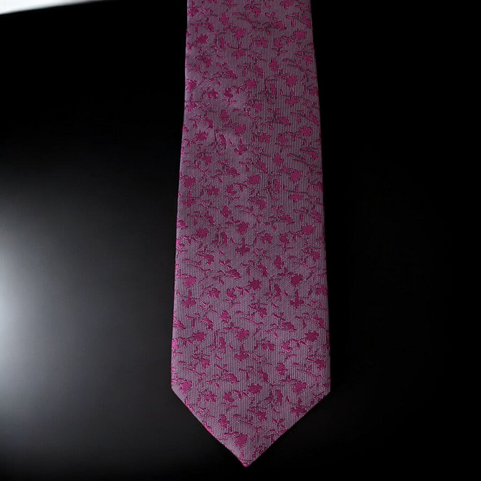 Pink floral patterned tie on a black background