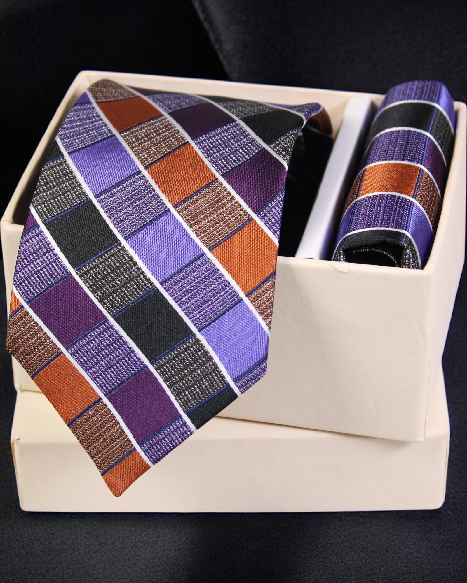 Striped tie and pocket square set in a box on a dark background Tie Benon