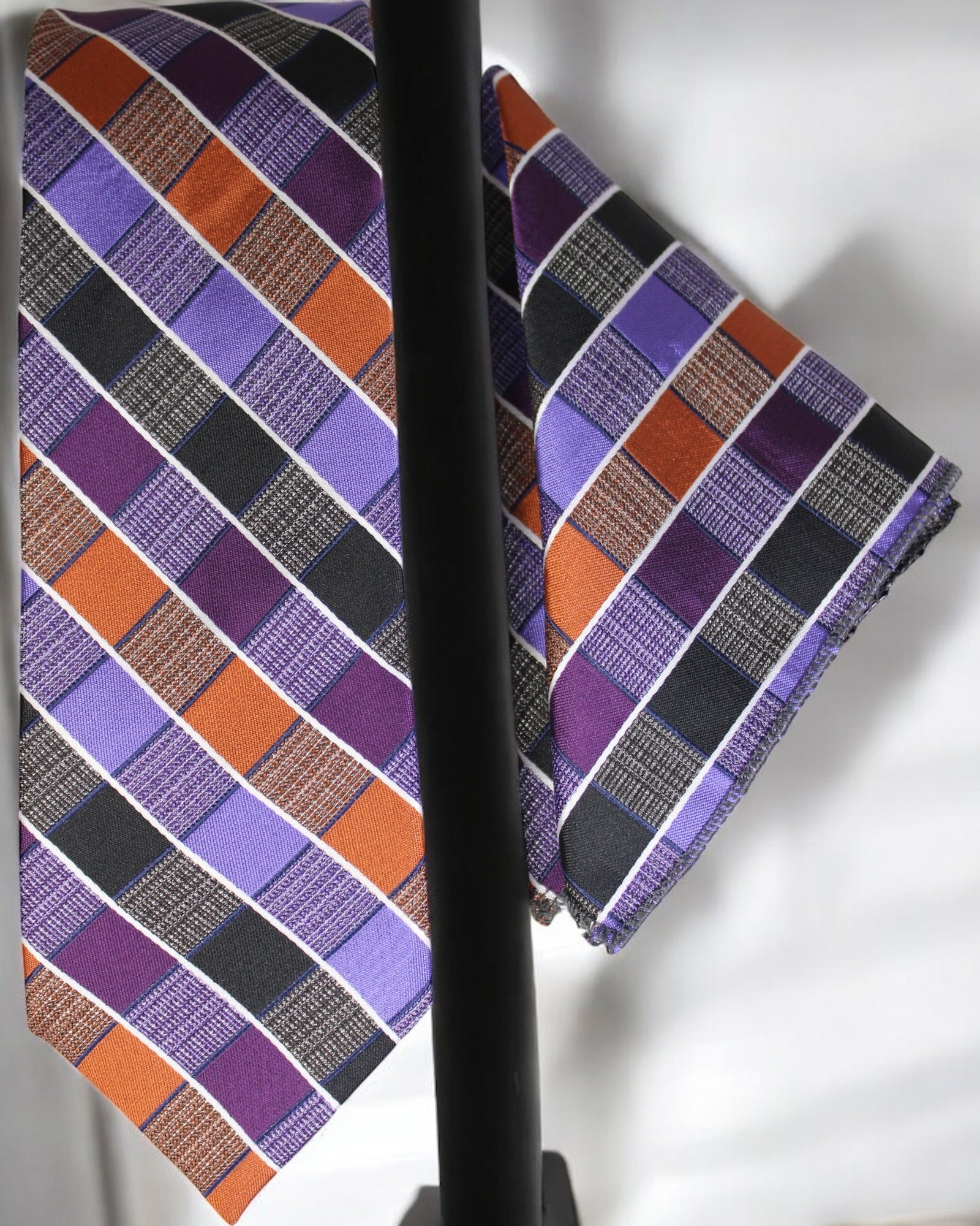 Plaid tie with purple, orange, and black pattern on a white background Tie Benon