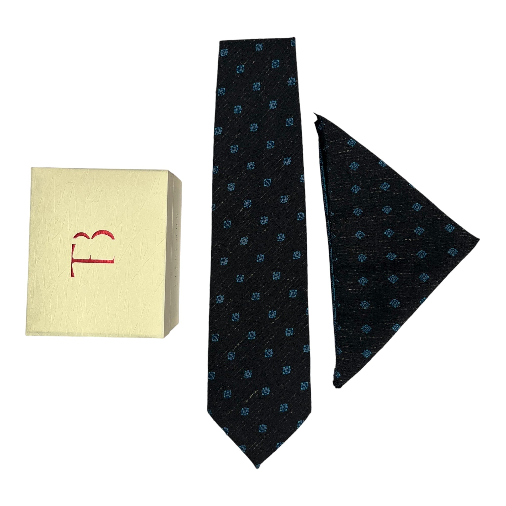 A black cashmere tie and pocket square combo with a geometric dot pattern, displayed with a letter 'T' on a yellow card and a small red box.