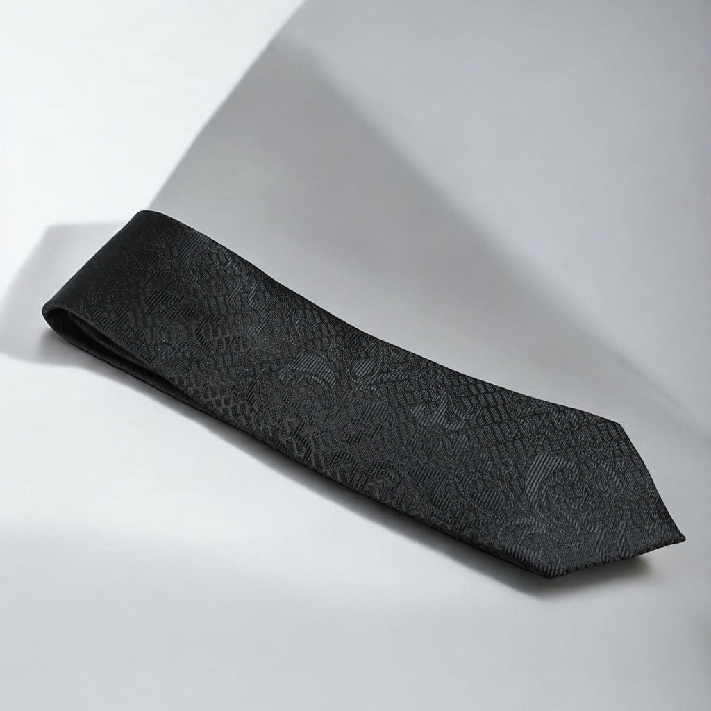 Black textured tie on a light gray background