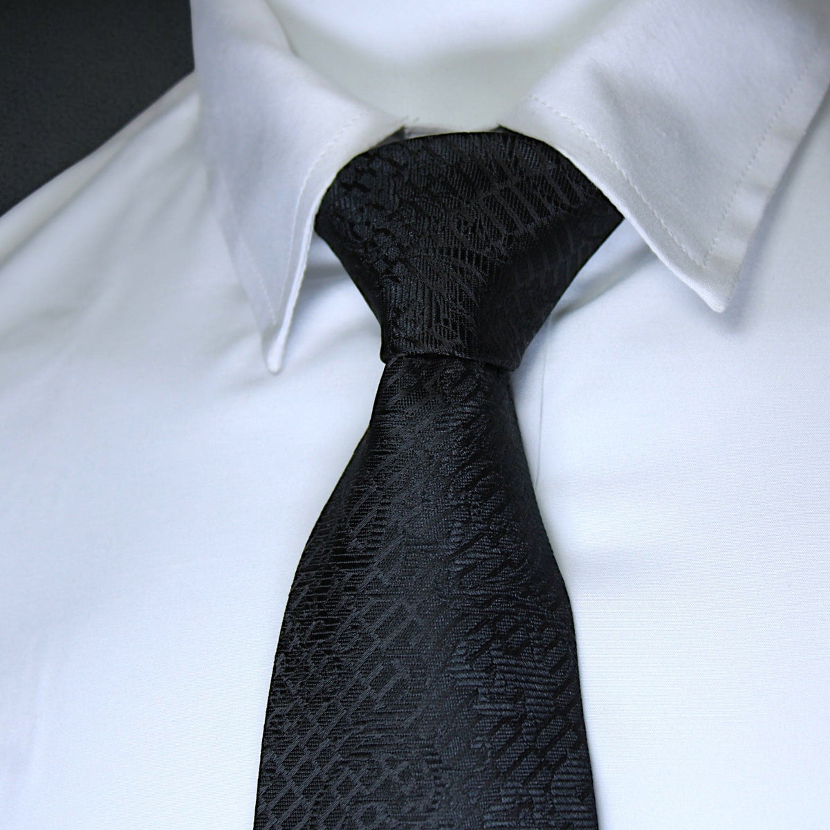 Black patterned tie on a white shirt