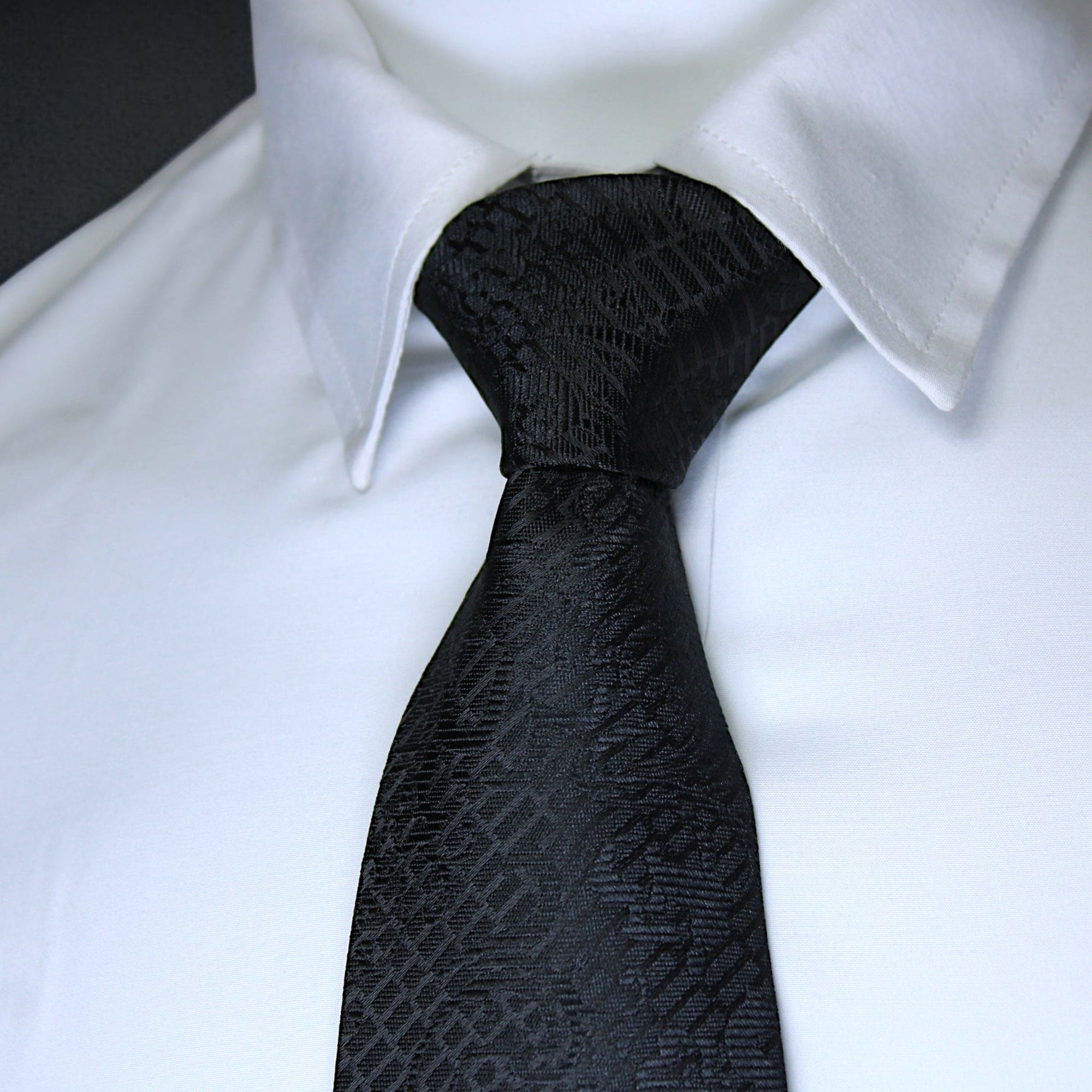Black patterned tie on a white shirt