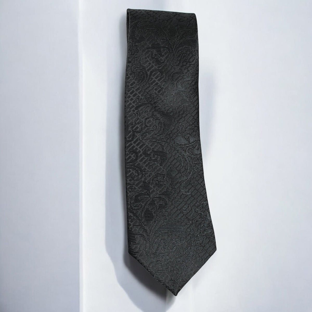 Black patterned tie on a white background