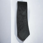 Black patterned tie on a white background