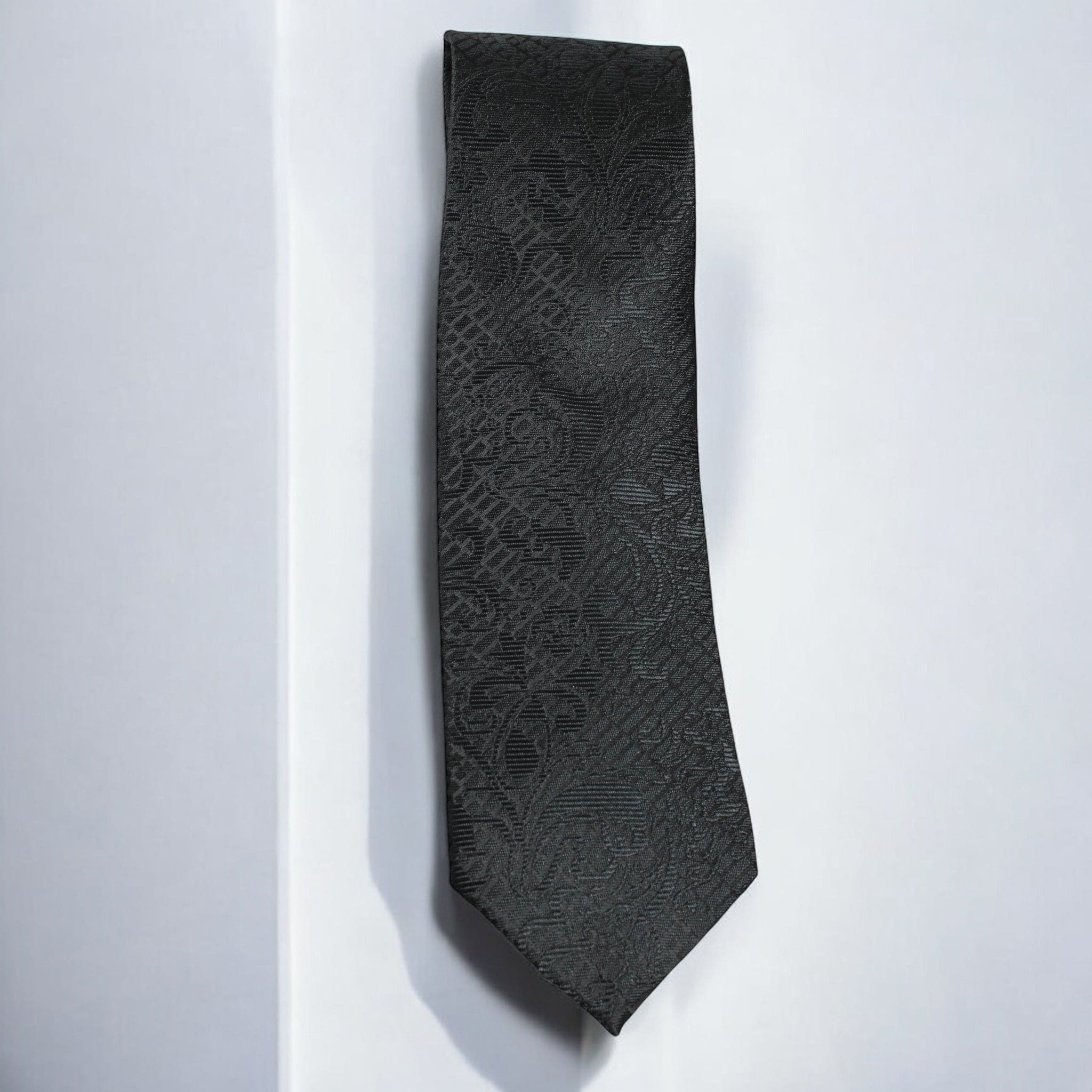 Black patterned tie on a white background