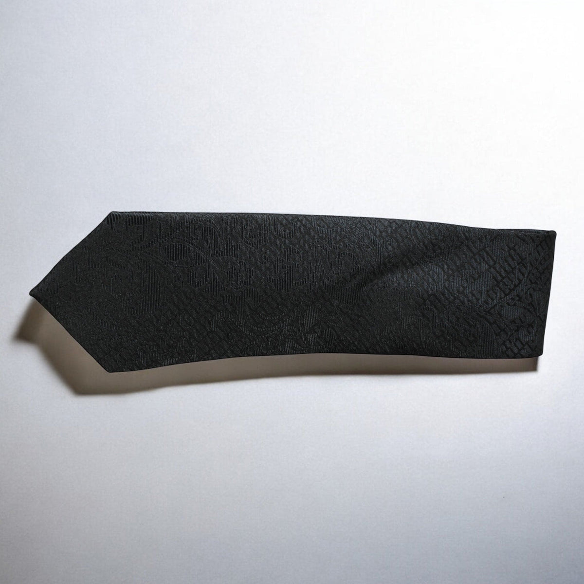 Black textured bandeau top on a light gray background