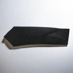 Black textured bandeau top on a light gray background