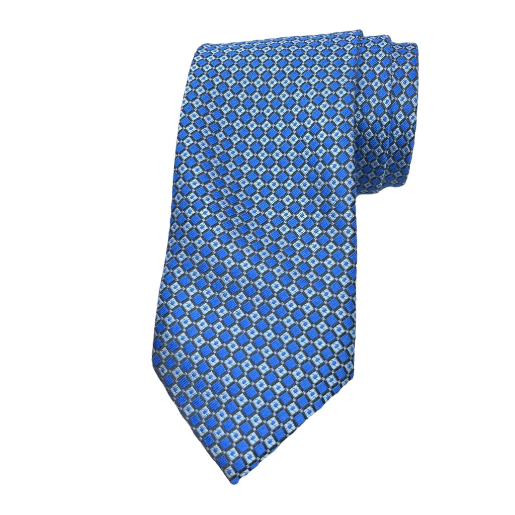 A blue classic woollen tie with a geometric pattern, displayed in a neatly folded state Tie Benon