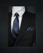 Mannequin wearing a black suit with a blue plaid tie and pocket square on a dark background Tie Benon