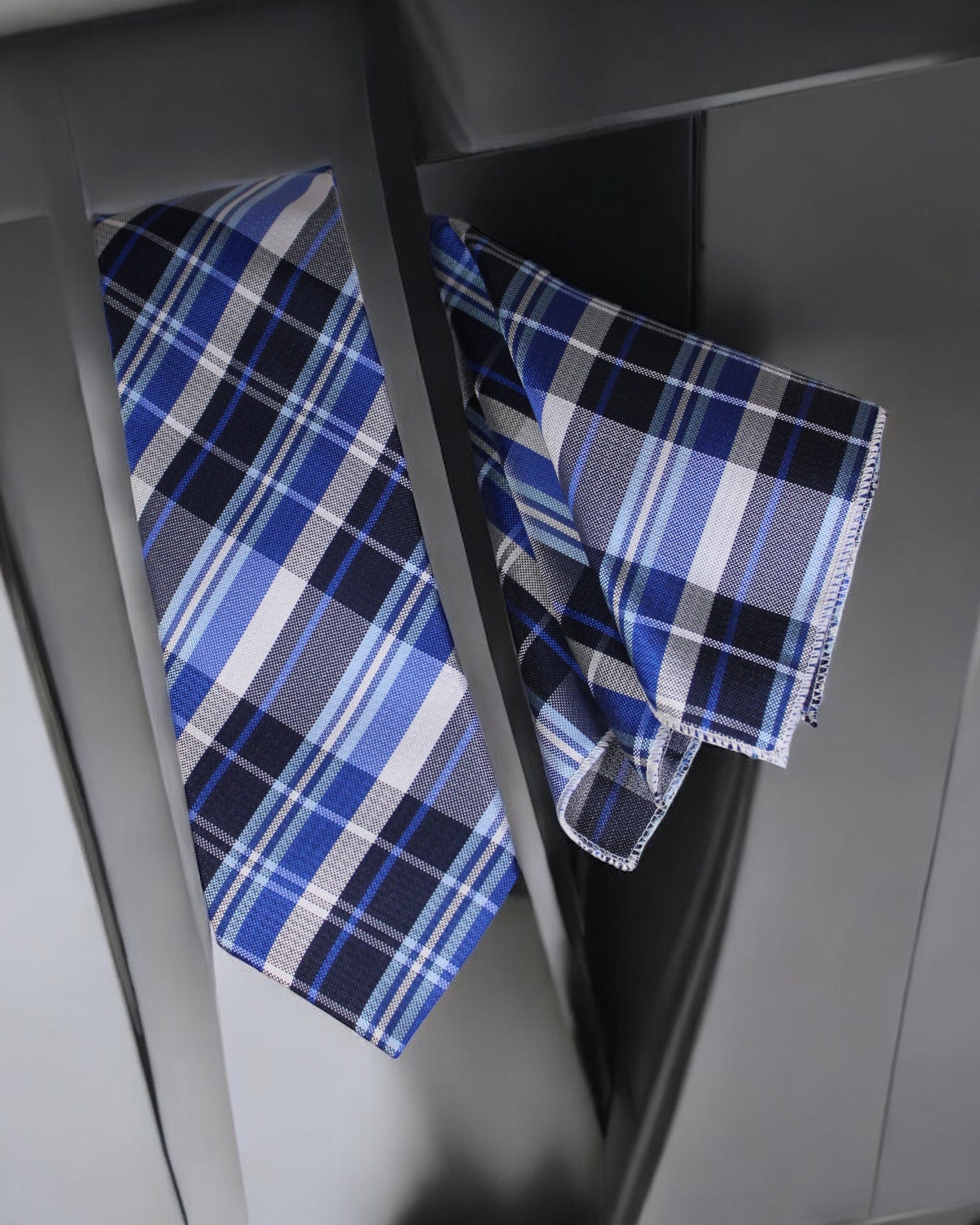 Blue and white plaid fabric on a metallic surface