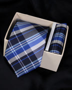 Blue plaid tie and pocket square set in a white box on a black background