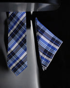 Blue plaid tie and pocket square set on a black background