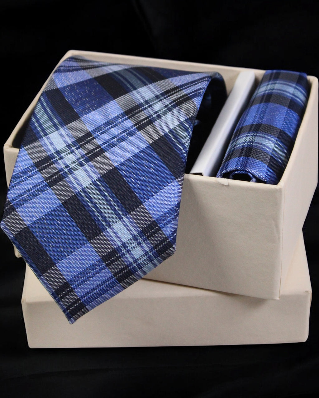 Blue plaid tie and pocket square set in a white box on a black background Tie Benon