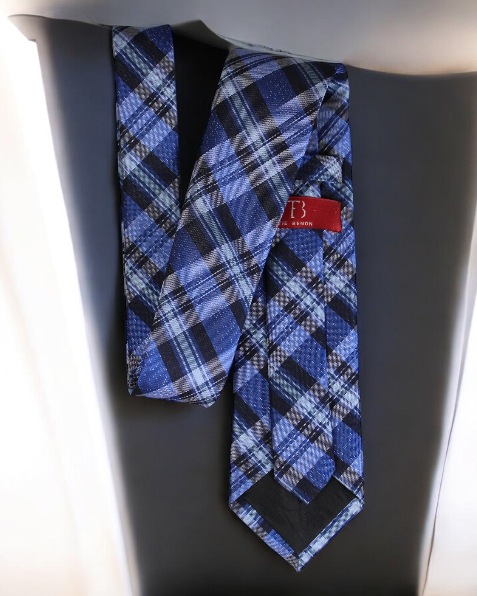 Blue plaid tie with a red label on a gray background Tie Benon
