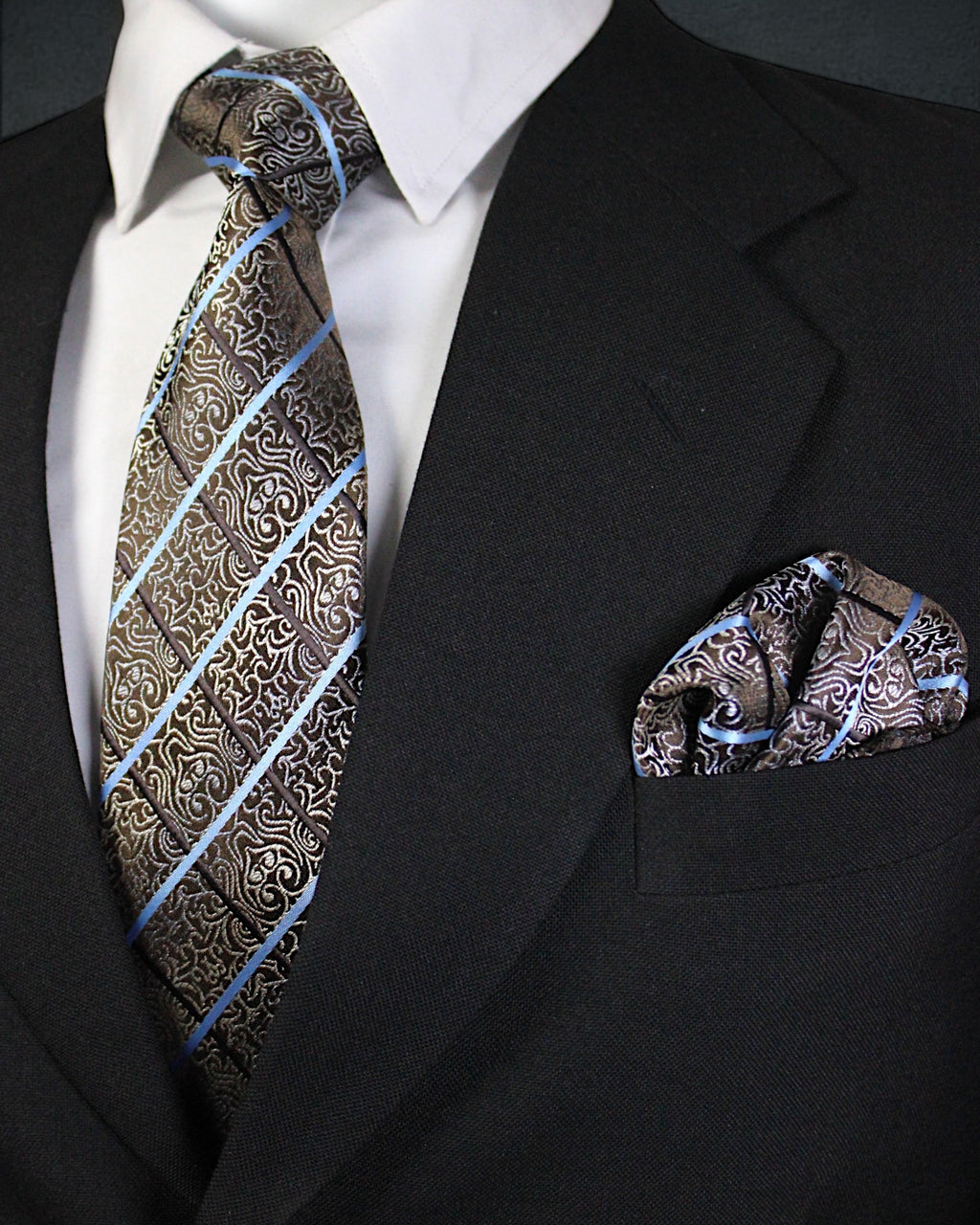Black suit with patterned tie and pocket square on a white background Tie Benon