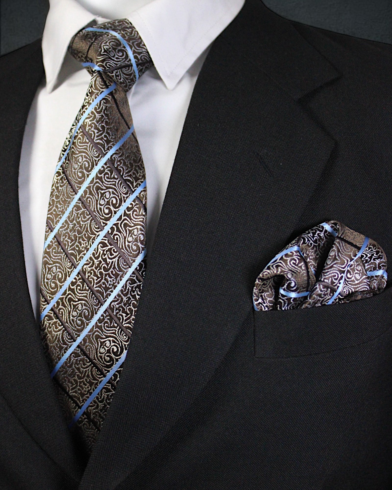 Black suit with patterned tie and pocket square on a white background Tie Benon
