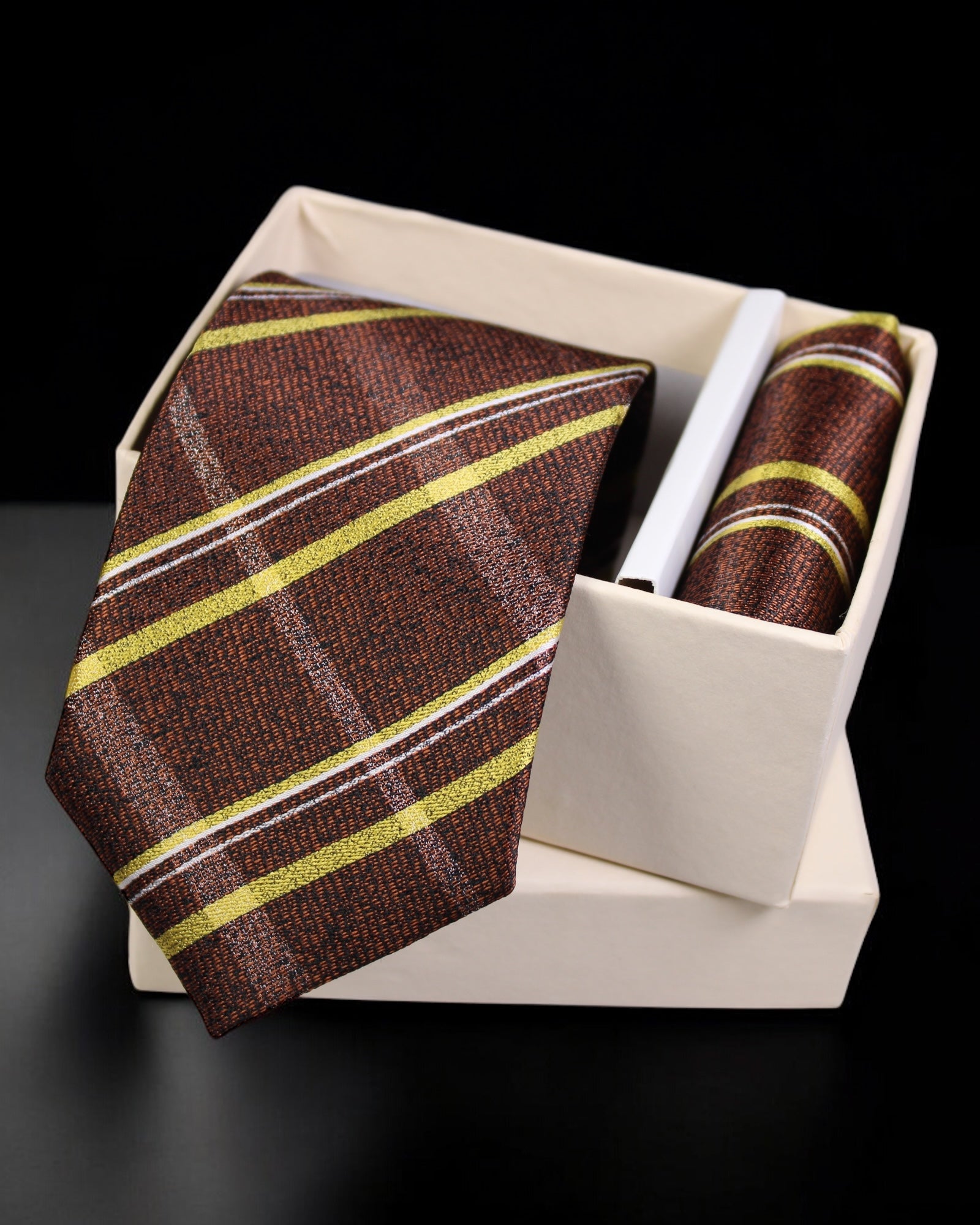 Brown striped tie with matching pocket square in a white box on a black background tie Benon