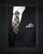Black suit with plaid tie and pocket square on a dark background tie Benon