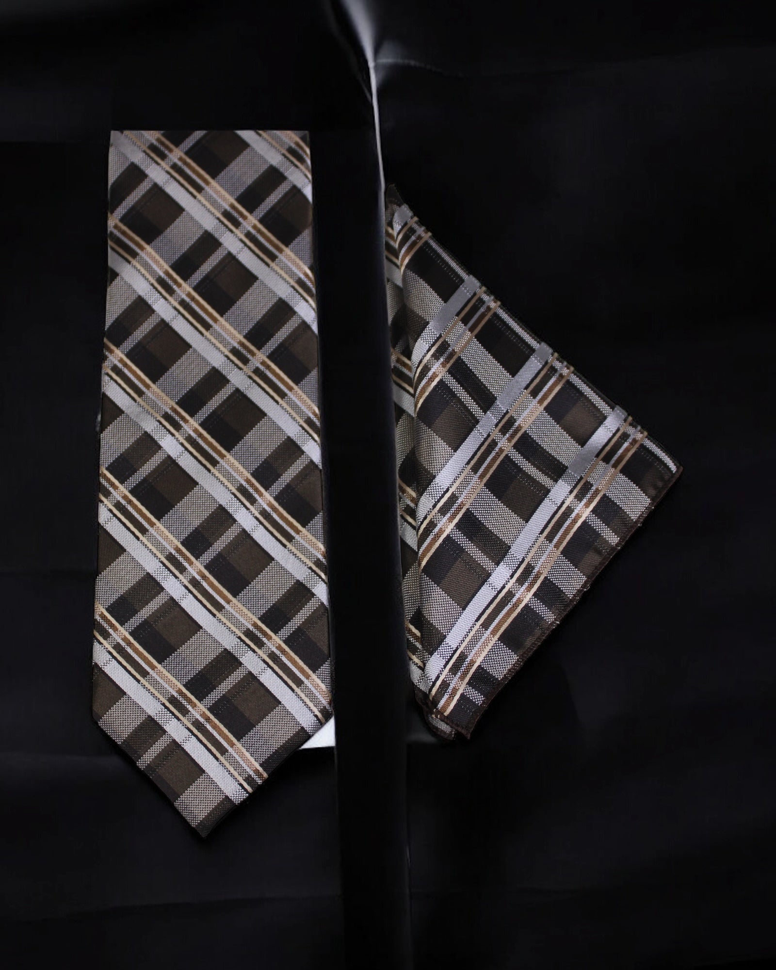 Plaid tie and pocket square set on a black background tie benon