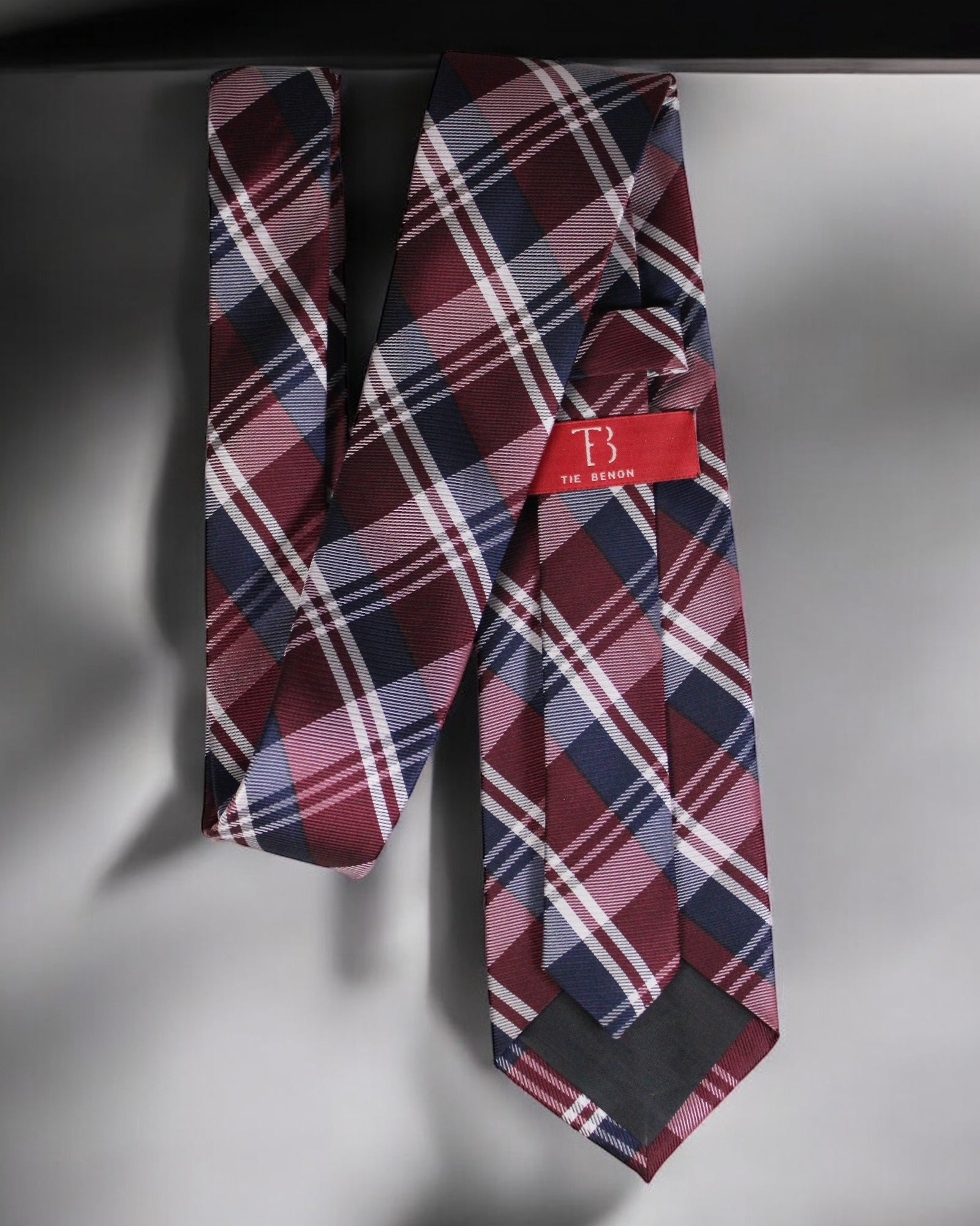Plaid tie with a red label on a gray background Tie Benon