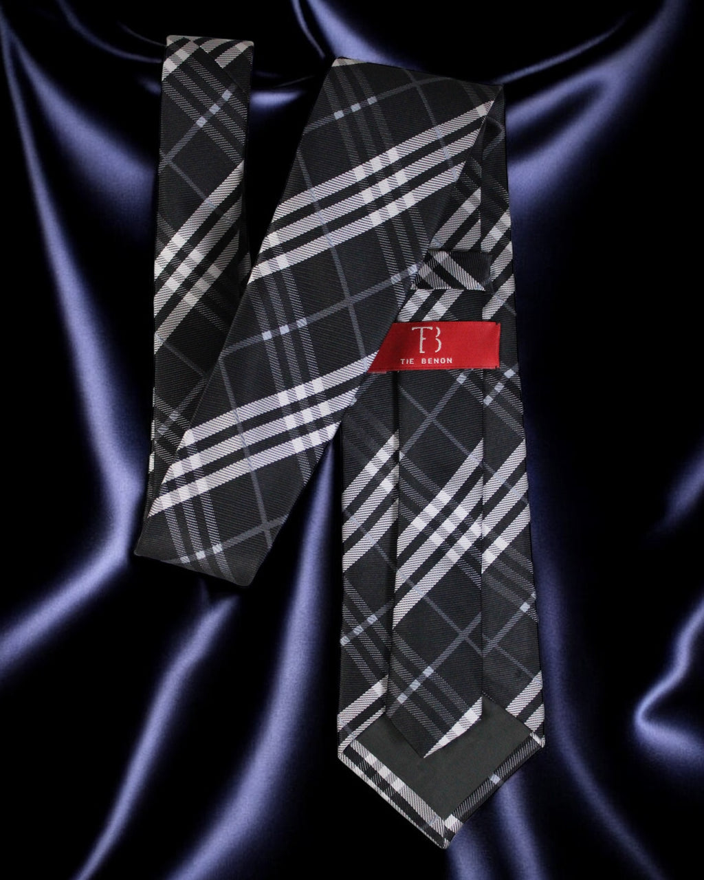 Plaid tie with a red label on a dark fabric background Tie Benon