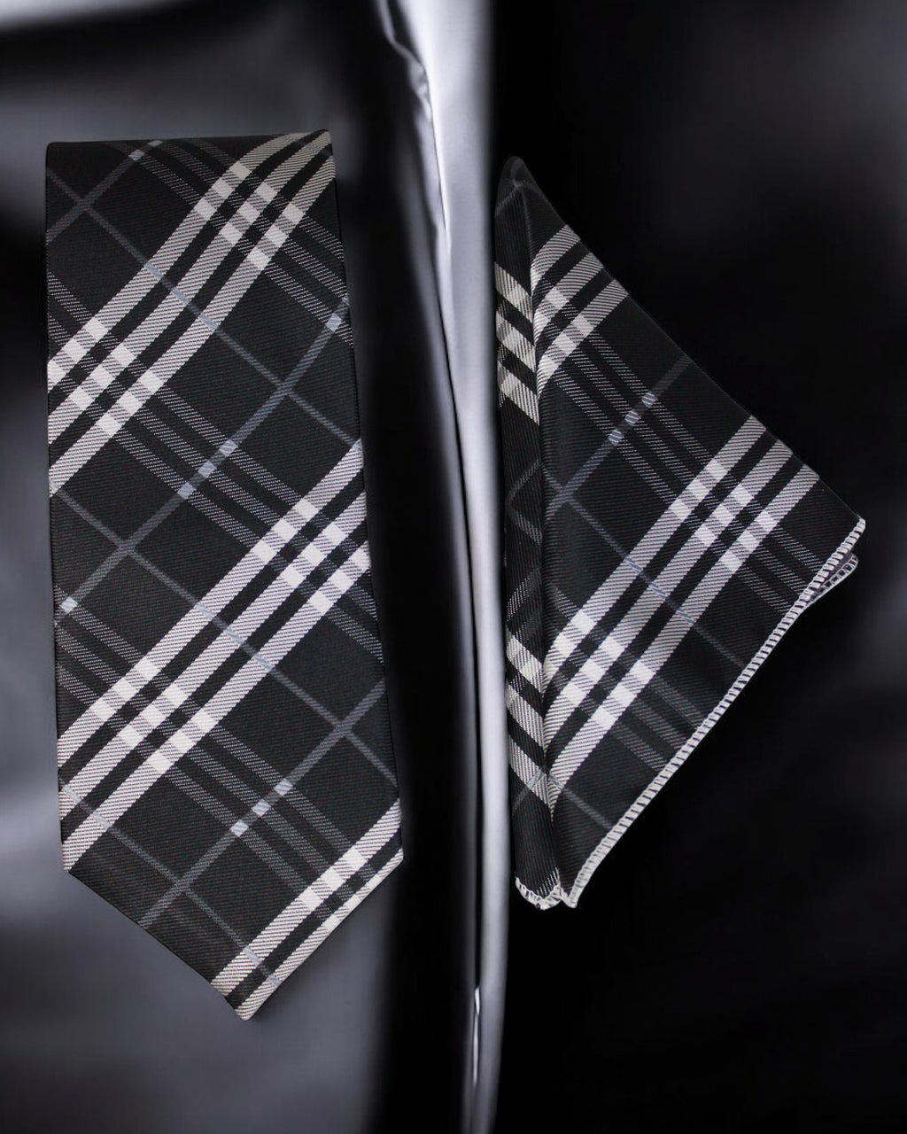 Black and white plaid tie and pocket square set on a dark background Tie Benon