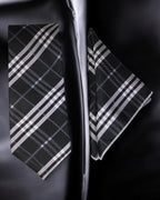 Black and white plaid tie and pocket square set on a dark background Tie Benon