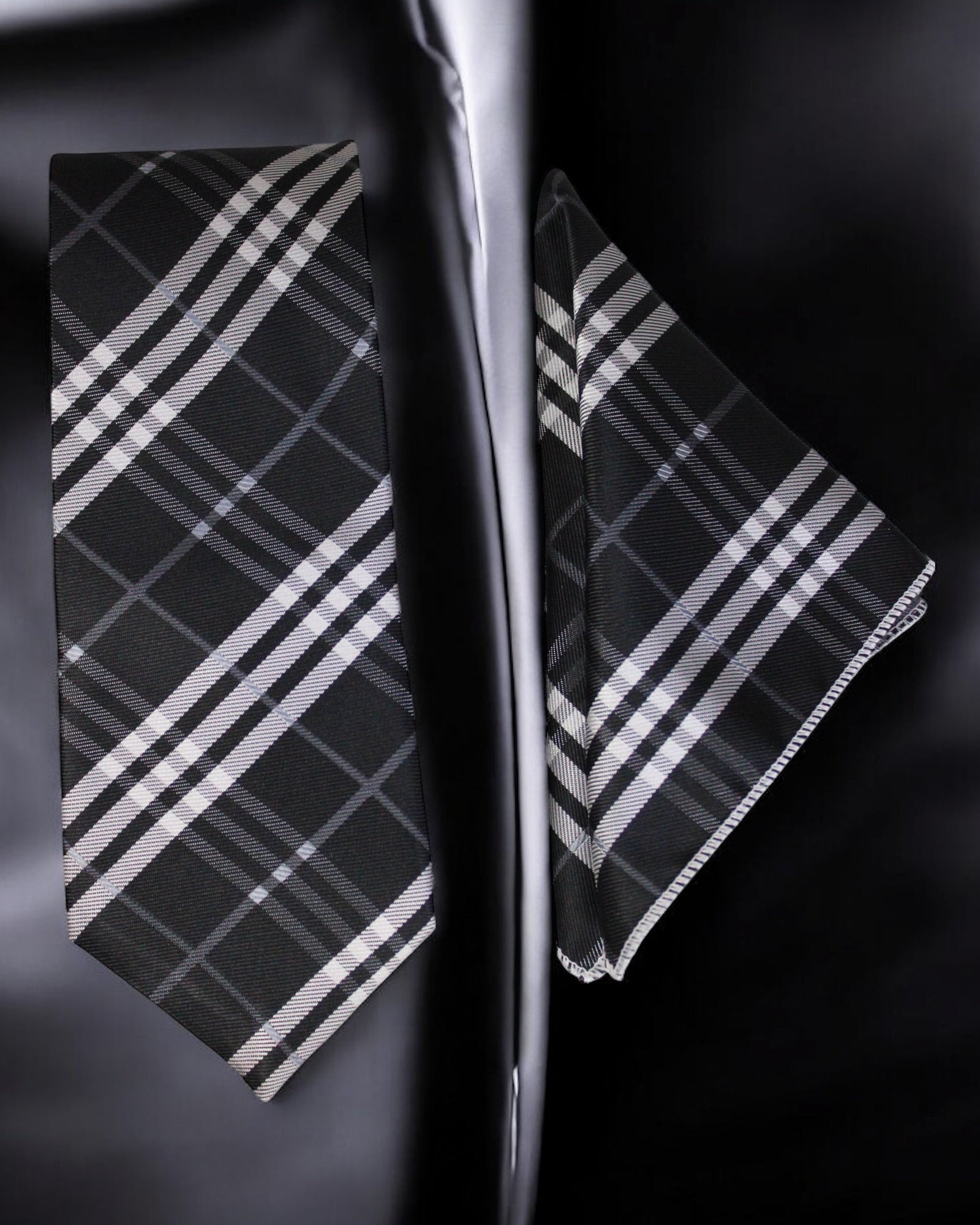 Black and white plaid tie and pocket square set on a dark background Tie Benon