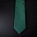 Green patterned tie on a black background