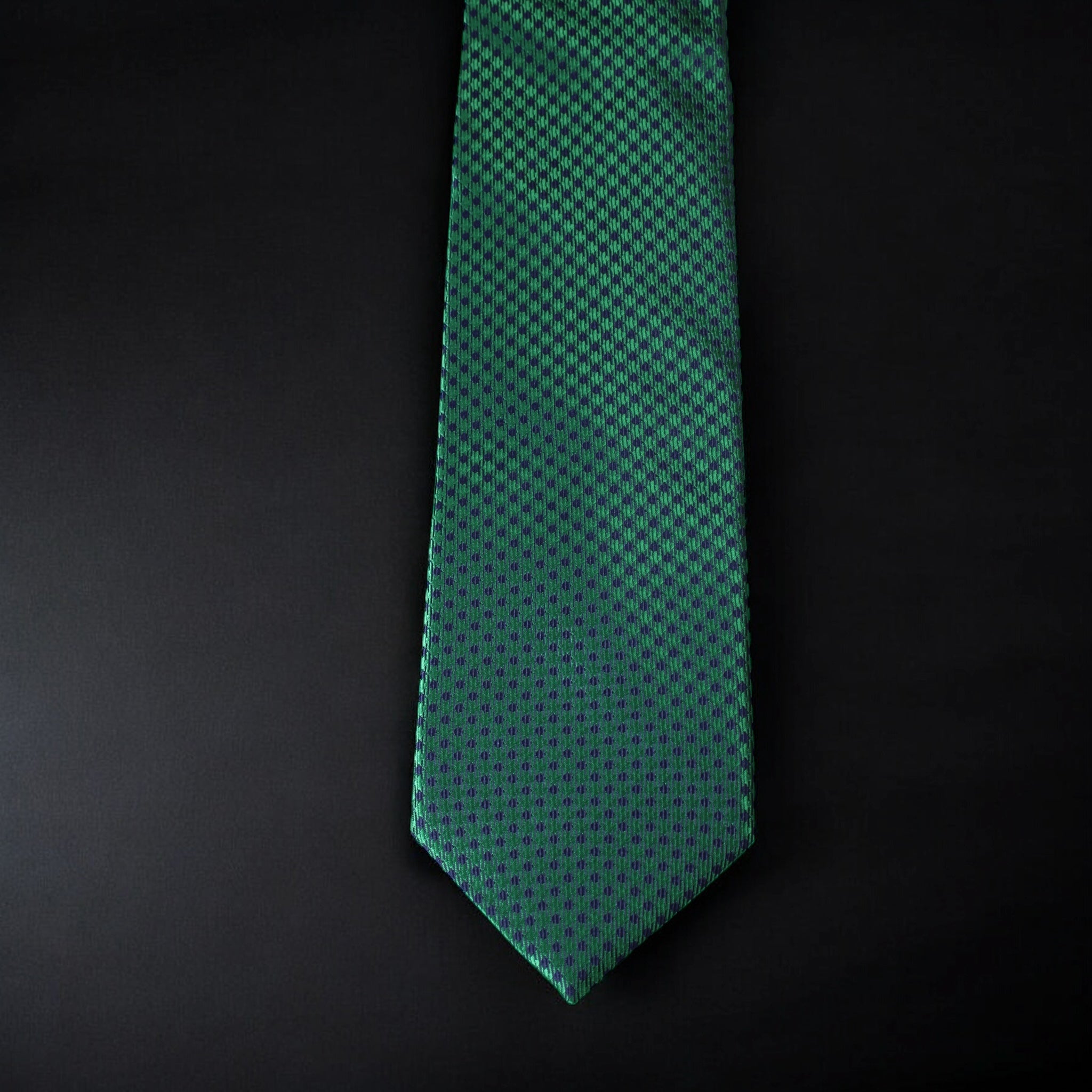 Green patterned tie on a black background