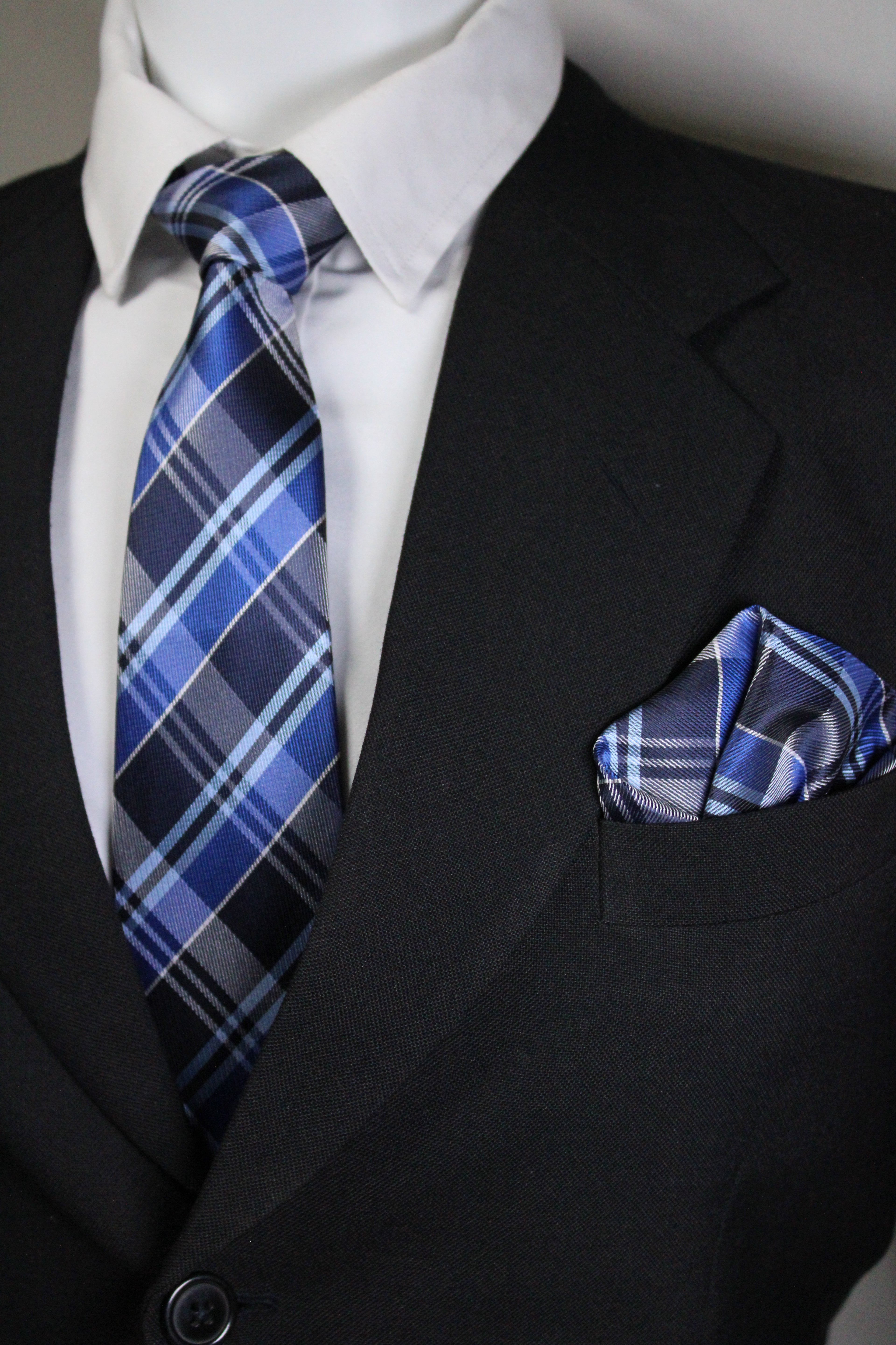 Blue plaid tie and pocket square on a suit jacket