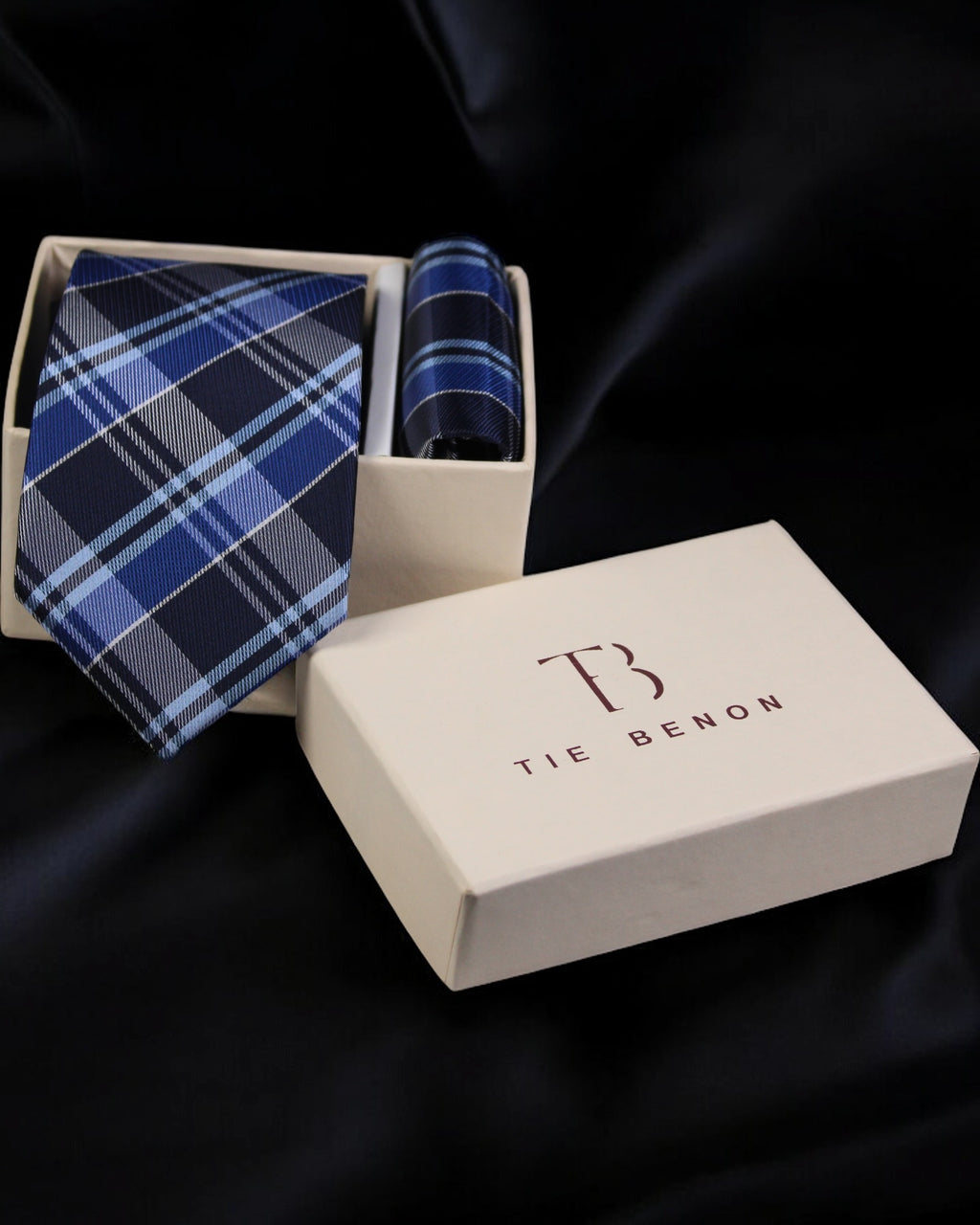 Blue plaid tie and matching pocket square in a Tie Benon box on a dark background