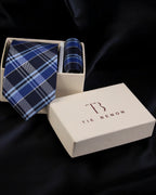 Blue plaid tie and matching pocket square in a Tie Benon box on a dark background