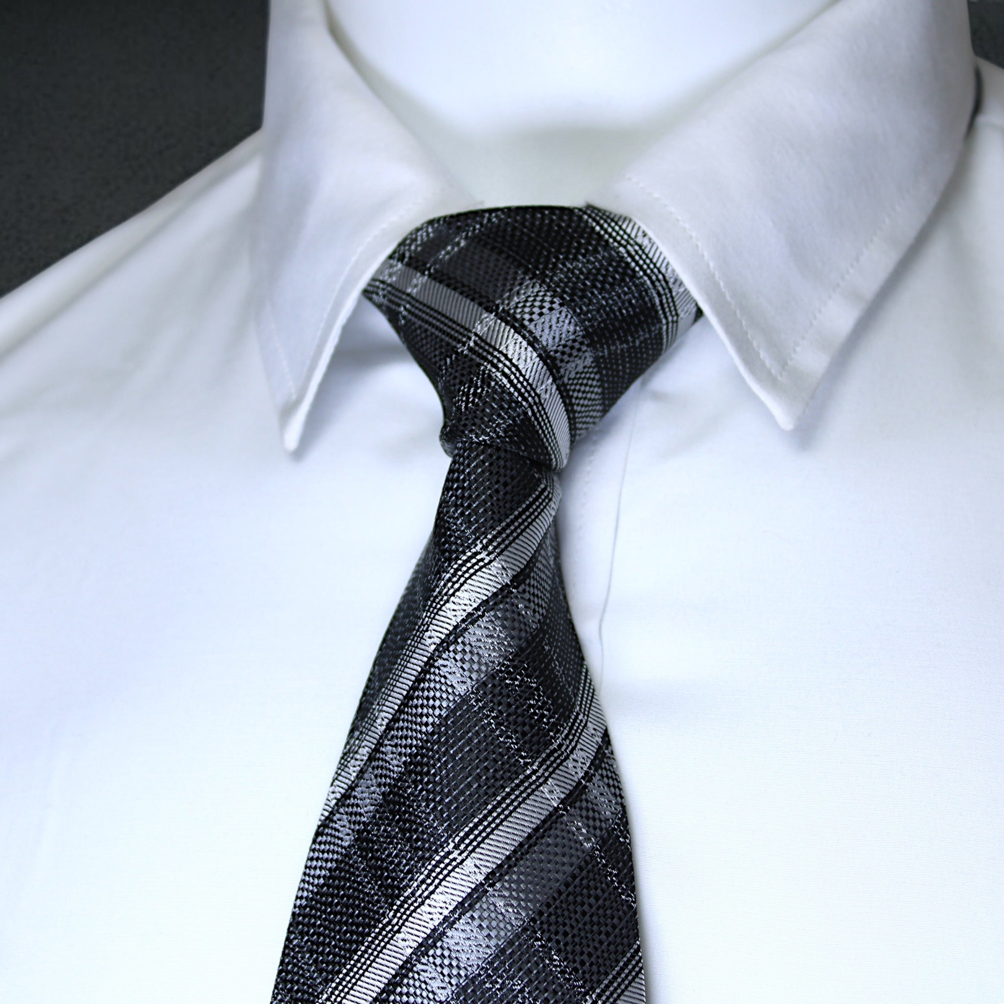 Black and silver striped tie on a white shirt