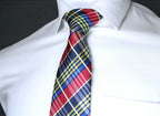 Colorful plaid tie on a white shirt against a black background