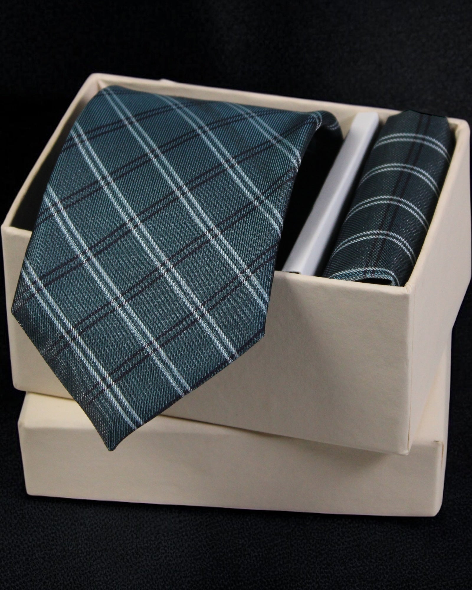 Teal plaid tie and pocket square set in a white box on a black background Tie Benon
