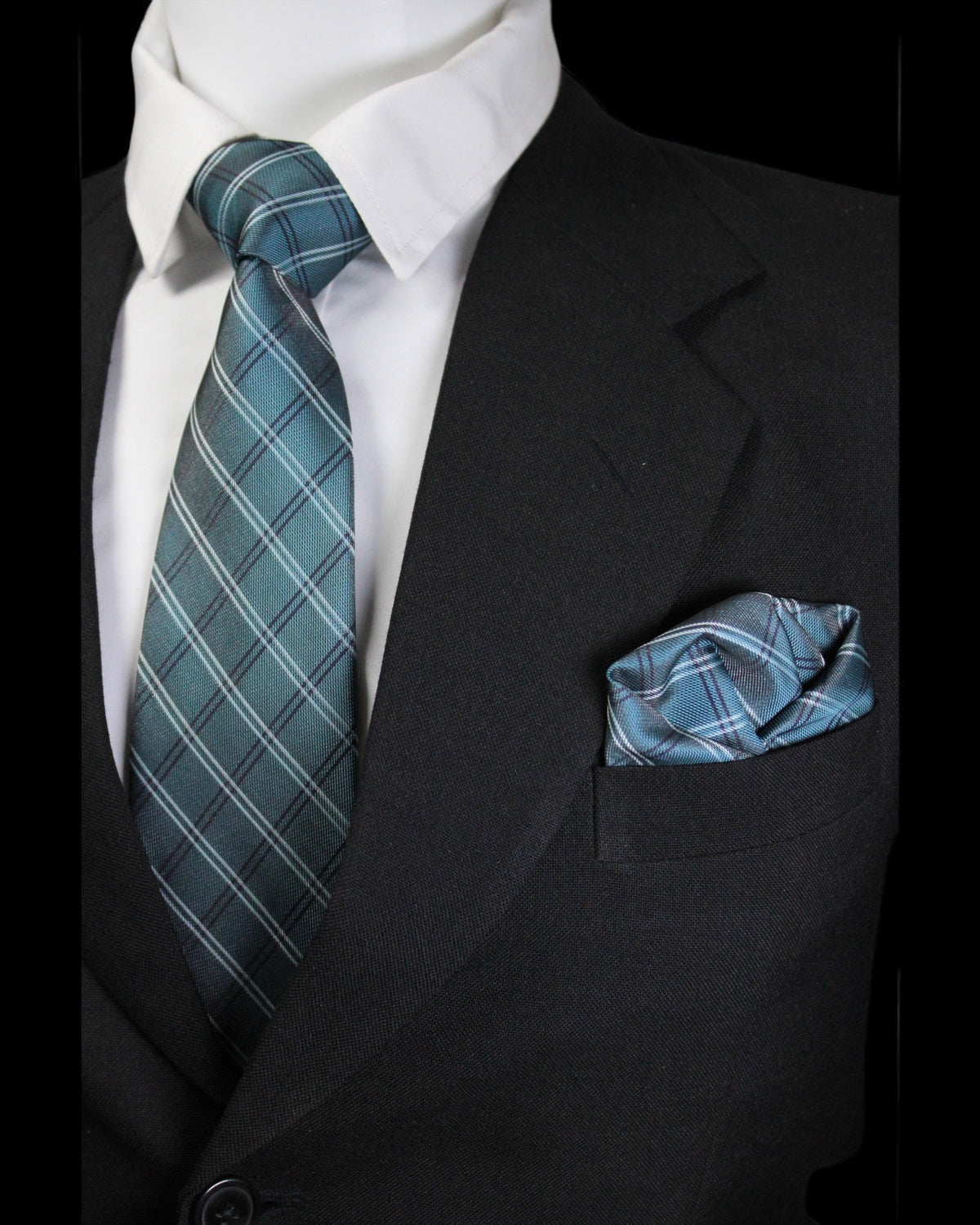 Black suit with white shirt, blue plaid tie, and matching pocket square Tie Benon