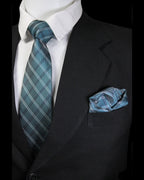 Black suit with white shirt, blue plaid tie, and matching pocket square Tie Benon