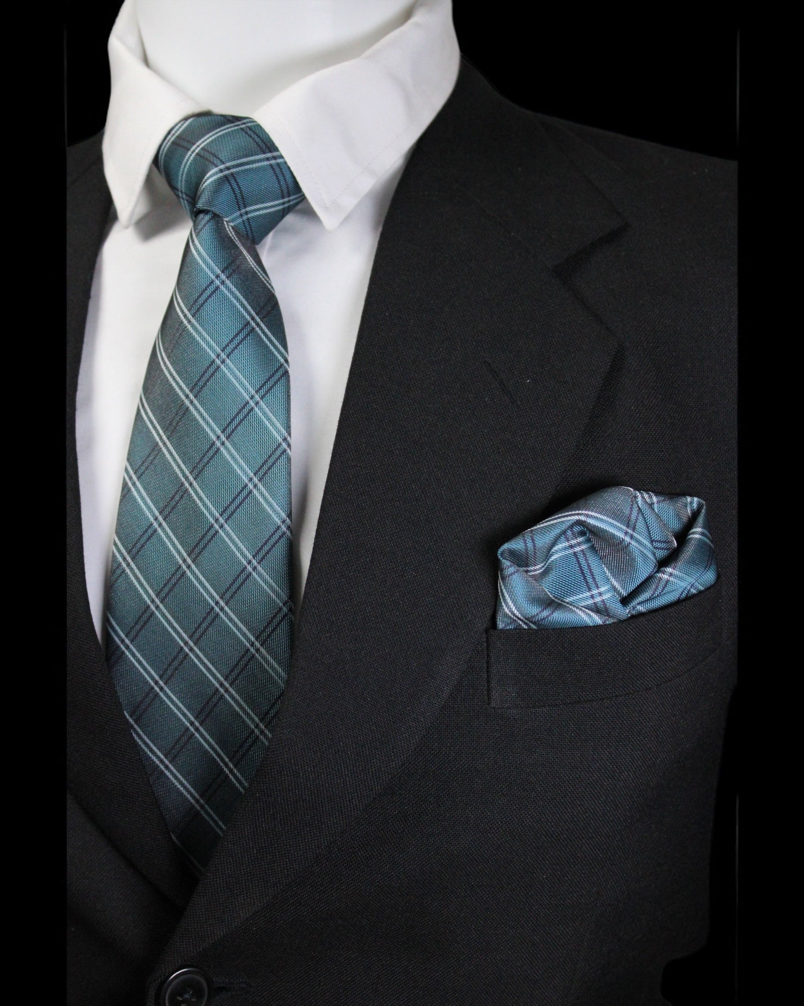 Black suit with white shirt, blue plaid tie, and matching pocket square Tie Benon