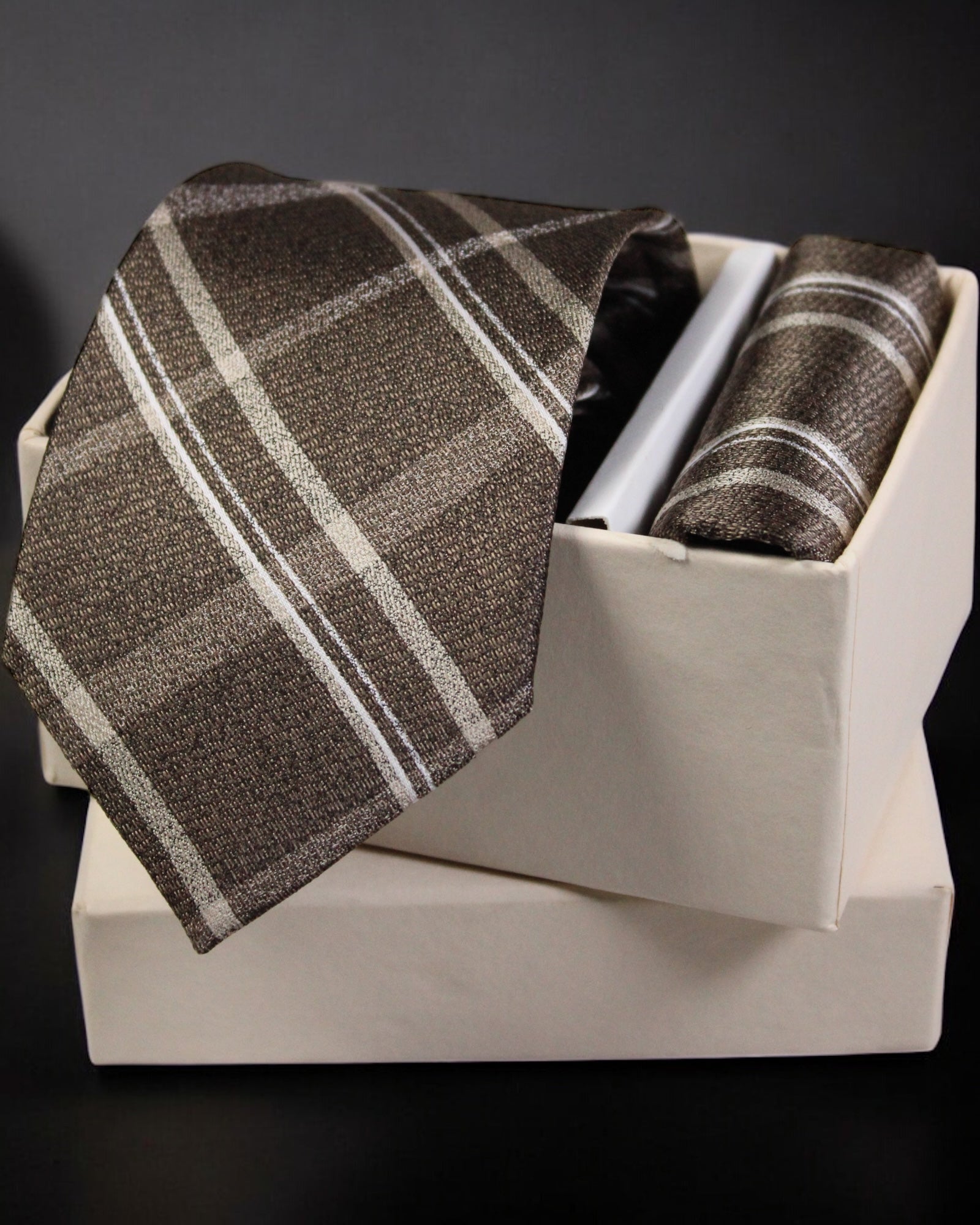 Brown plaid tie and pocket square set in a white box on a dark background Tie Benon