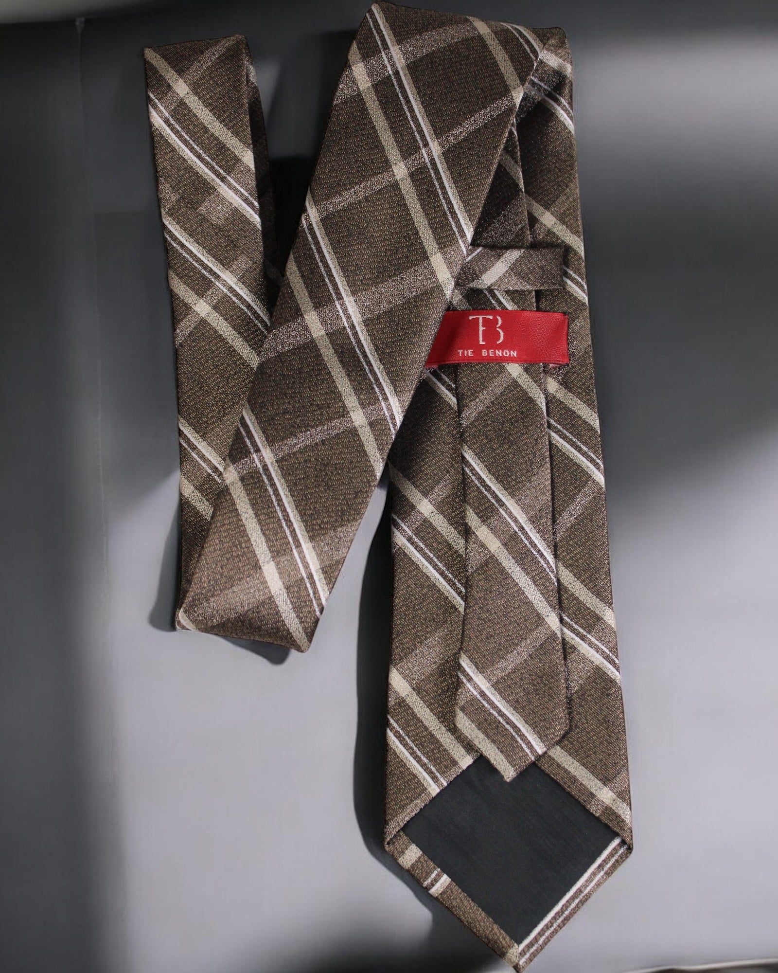 Brown plaid tie with a red label on a gray background Tie Benon