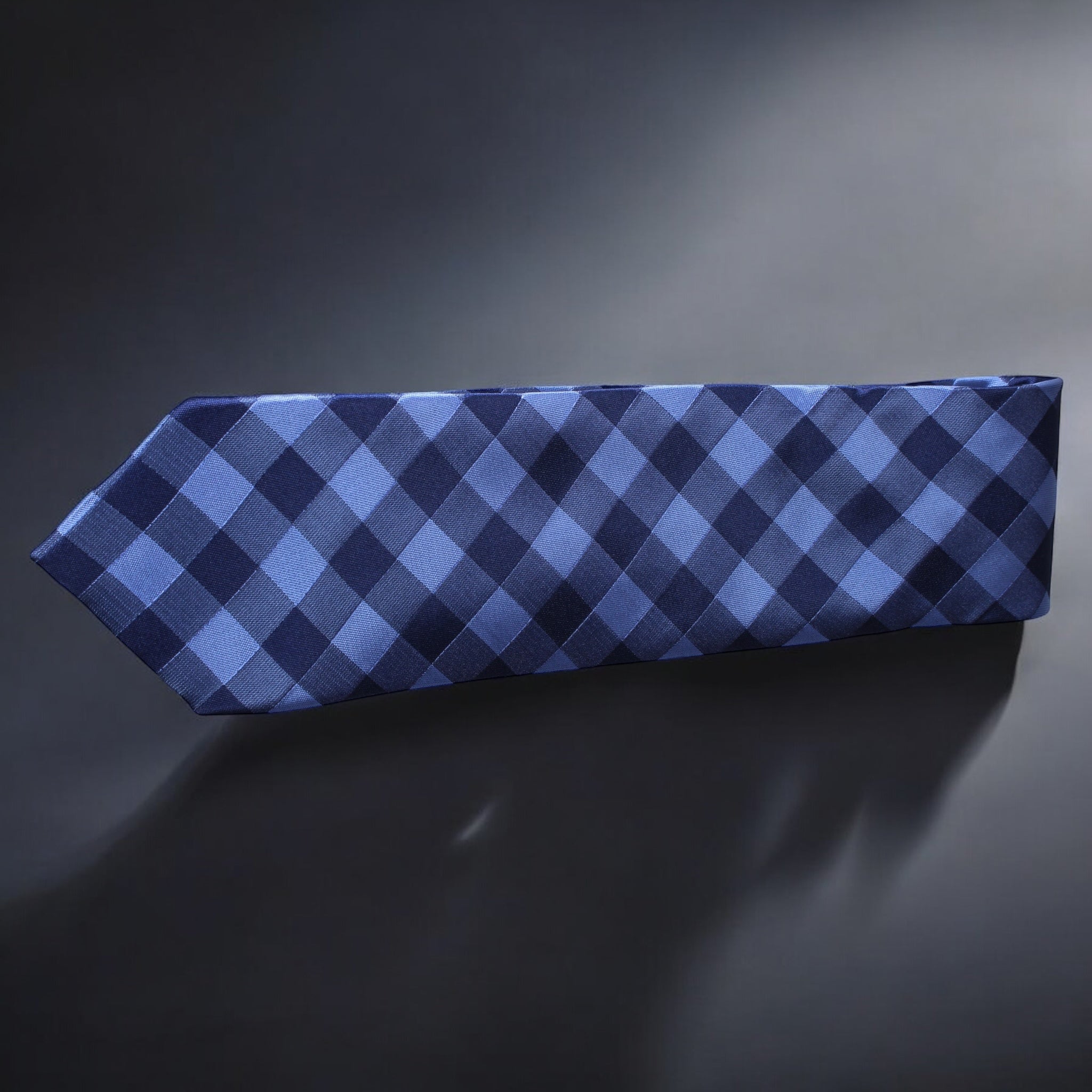 Blue and black checkered tie on a dark gray background