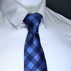 Blue checkered tie on a white shirt with a blurred background
