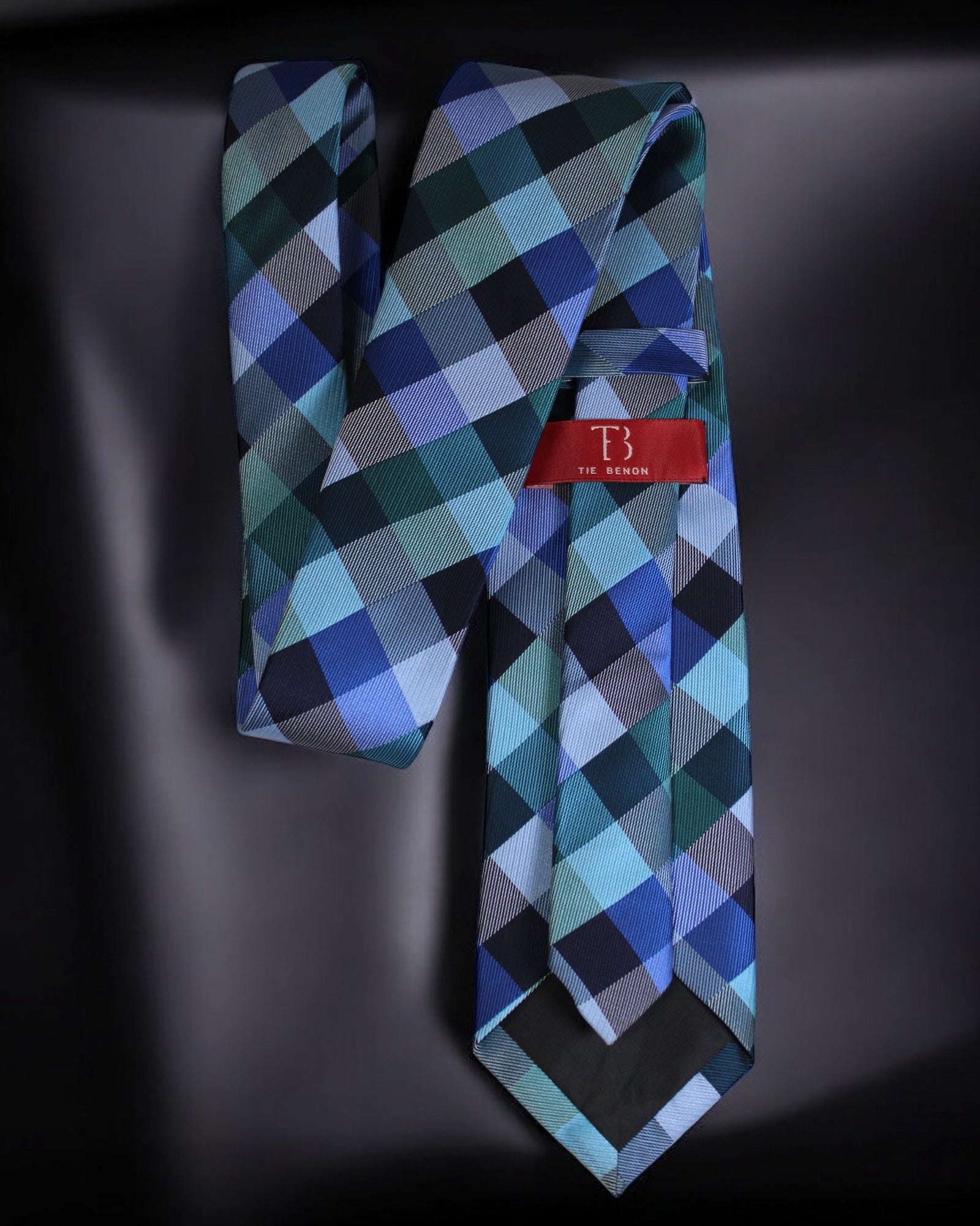 Plaid tie with a red label on a dark background Tie Benon